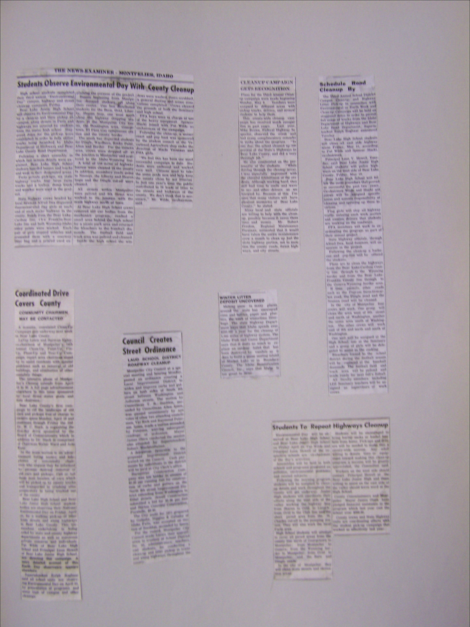 Several newspaper clippings are arranged on a plain surface. The headlines include topics about environmental cleanup efforts, student involvement in county cleanup activities, and a council's street ordinance. There are references to locations such as Montpelier, Idaho. The articles discuss coordinated drives, cleanup campaigns, student participation, and local ordinances.