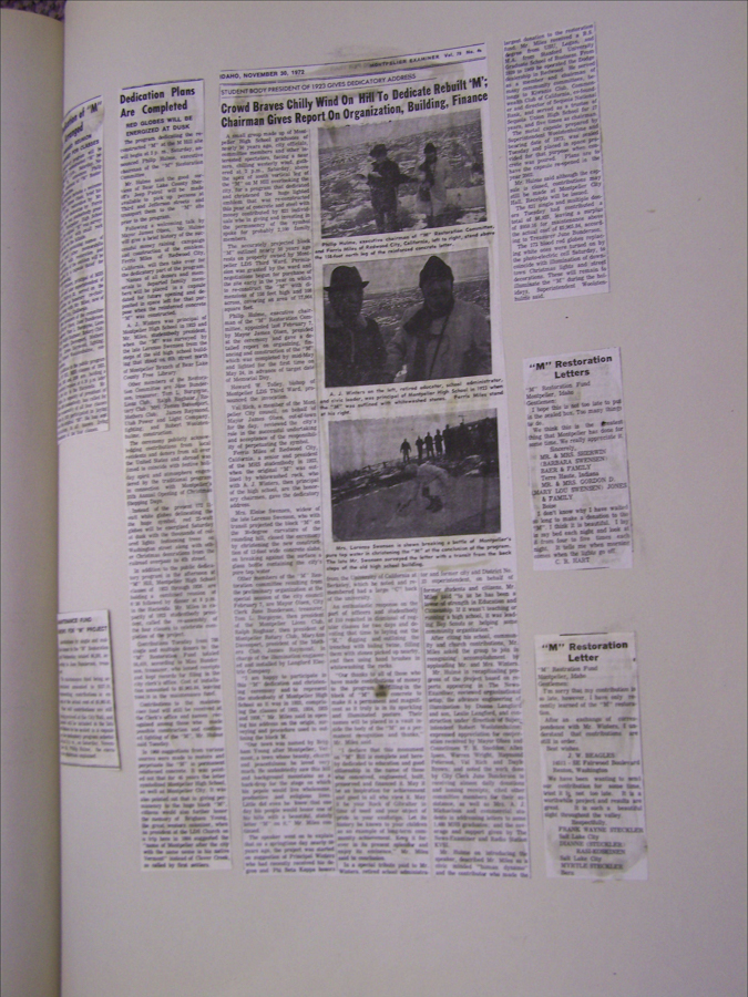 A collection of newspaper clippings arranged on a flat surface. The central article features the headline: "Crowd Braves Chilly Wind On Famed Hill To Dedicate Rebuilt 'M'; Chairman Gives Report On Organization, Building, Finance" and includes three photographs of people in winter clothing in an outdoor setting. To the left, other articles with varied text discuss dedication plans and other related topics. On the right, a column titled "'M' Restoration Letters" lists names and details related to a restoration fund.