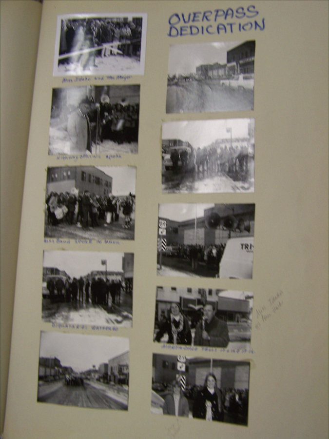 A collage featuring several images arranged on a page. At the top, large text reads "OVERPASS DEDICATION." The images depict groups of people in a street setting, possibly during a ceremonial event. Captions below the images include phrases like "Miss Jindra and the Mayer," "Manayunkville speaks," "Seni Band Poets Music," "Dignitary opening," and "Athabatibe Press ouctisdhe." There are additional handwritten notes on the side.