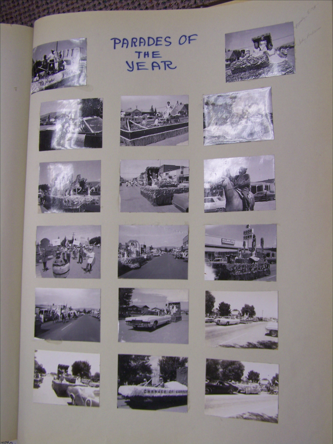 A collection of sixteen small images arranged in a grid on a page. The top of the page features handwritten text stating "PARADES OF THE YEAR." The images depict various parade scenes with floats and people. Some floats have recognizable structures or themes, such as boats, cars, and figures. One image includes a building with a sign that reads "Food Town." Another float has the text "Chamber of Commerce" on it. There are handwritten annotations next to two of the images on the right side.
