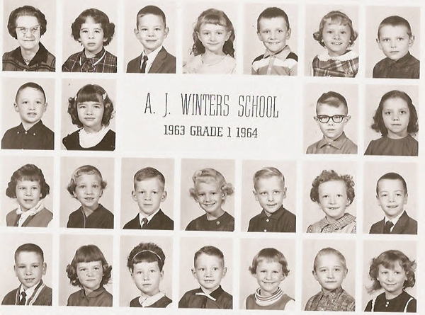 A collage of twenty-four individual portraits of young children arranged around the text, "A. J. Winters School 1963 Grade 1 1964." The children are shown in formal attire, with various hairstyles, arranged in three rows.