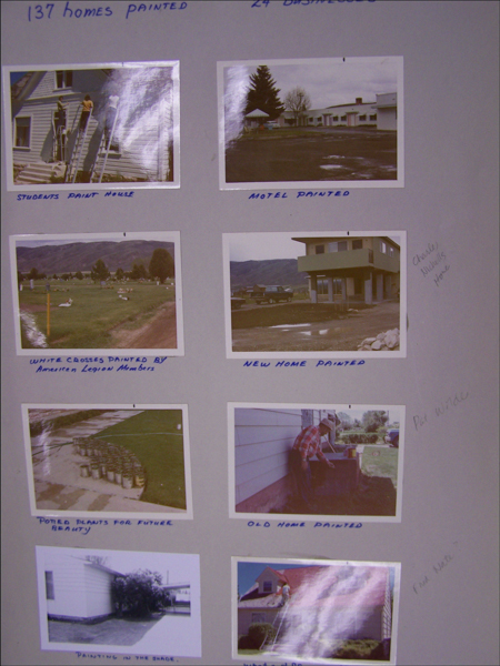 A collage with various images and handwritten captions. 

1. Top-left: A person on a ladder painting the side of a house. Caption: "STUDENTS PAINT HOUSE."
2. Top-right: A view of a motel with several buildings. Caption: "MOTEL PAINTED."
3. Middle-left: A field with white crosses, ducks, and trees in the background. Caption: "WHITE CROSSES PAINTED BY American Legion Members."
4. Middle-right: A two-story house with a car parked nearby. Caption: "NEW HOME PAINTED." Handwritten text beside this: "Charles Nichols Home."
5. Center-left: A row of potted plants arranged on grass. Caption: "POTTED PLANTS FOR FUTURE BEAUTY."
6. Center-right: A person in a plaid shirt and hat painting the side of a house. Caption: "OLD HOME PAINTED." Handwritten text beside this: "Pat Wade."
7. Bottom-left: The side of a house with a shady area and bushes. Caption: "PAINTING IN THE SHADE."
8. Bottom-right: An individual standing on a roof using a paint roller on an extended pole. Caption: "WHAT A FINISH."

At the top of the collage, there's the text "137 HOMES PAINTED" and "24 DISABLED."
