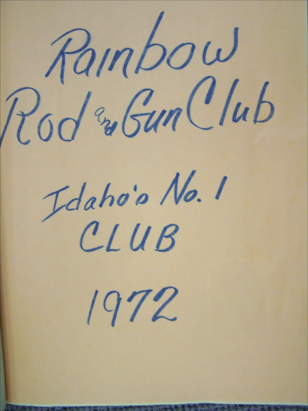 Handwritten text on a surface reads: "Rainbow Rod and Gun Club, Idaho's No.1 CLUB, 1972."