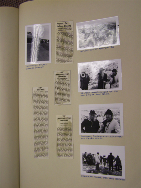A collection of newspaper clippings and photographs arranged on a page. The top left has a photo labeled "Christening by Mrs. Lorenzo Swenson," depicting a person near a car. Next to it, a clipping titled "Prepare for Holiday Opening." On the right, a photo labeled "'M' Hill View of Montpelier" shows a landscape. Below that, a photo with three people is labeled "Val Rich accepts project 'M' for the city of Montpelier." Below are names "Honorary Co-Chairmen - A.J. Winters and Ferris Miles." A longer column on the left lists "'M' Donors" and another "'M' Restoration Donors." A final photo at the bottom shows a group with "Chairman Hulme delivers address" written beneath.