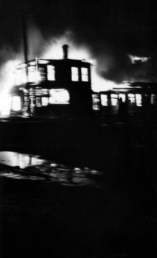 Night time image of the forest fire burning buildings in Wallace, Idaho August 20, 1910.
