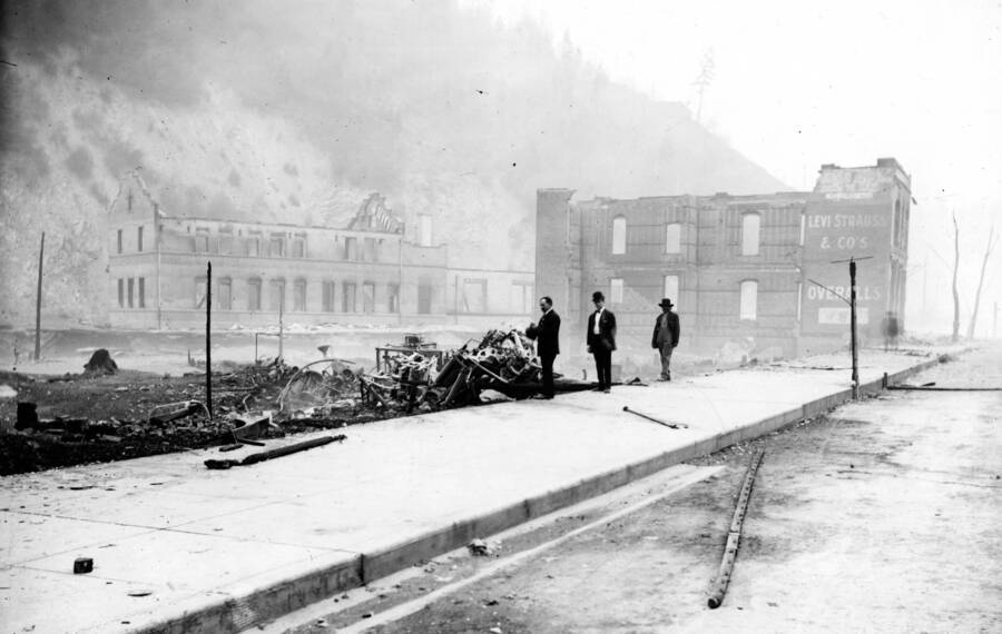 Image shows the remains of brick building at 721 Bank Street and, in background, O.R. & N railroad depot, after fire of August 20, 1910.