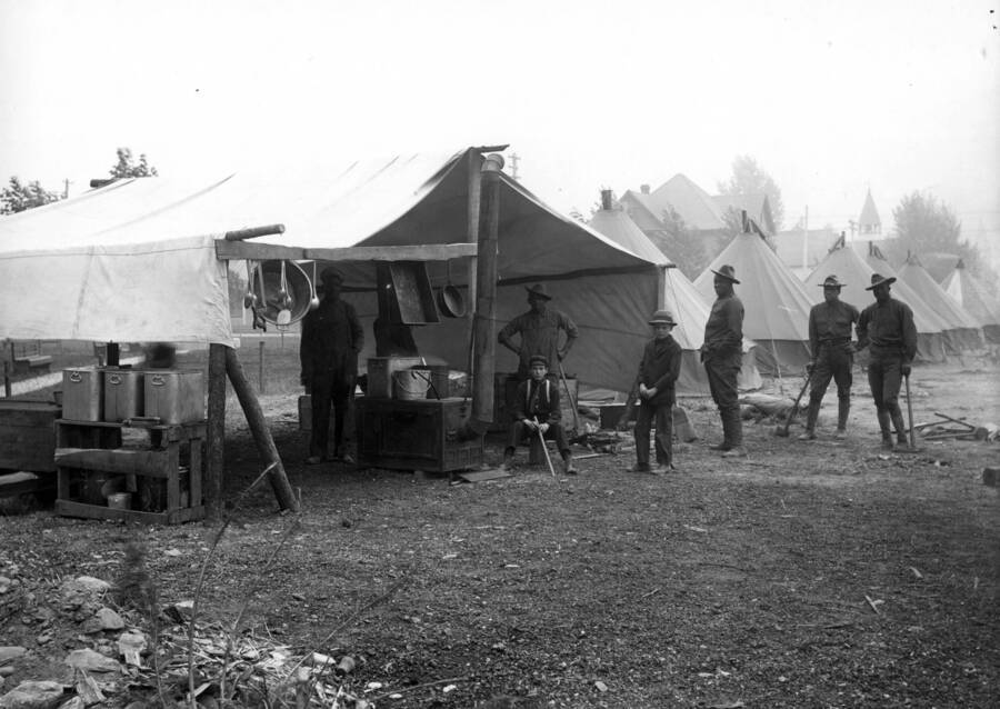 Images shows tents of a Black soldiers camp set up outside of Wallace, Idaho. Forest fire 1910.