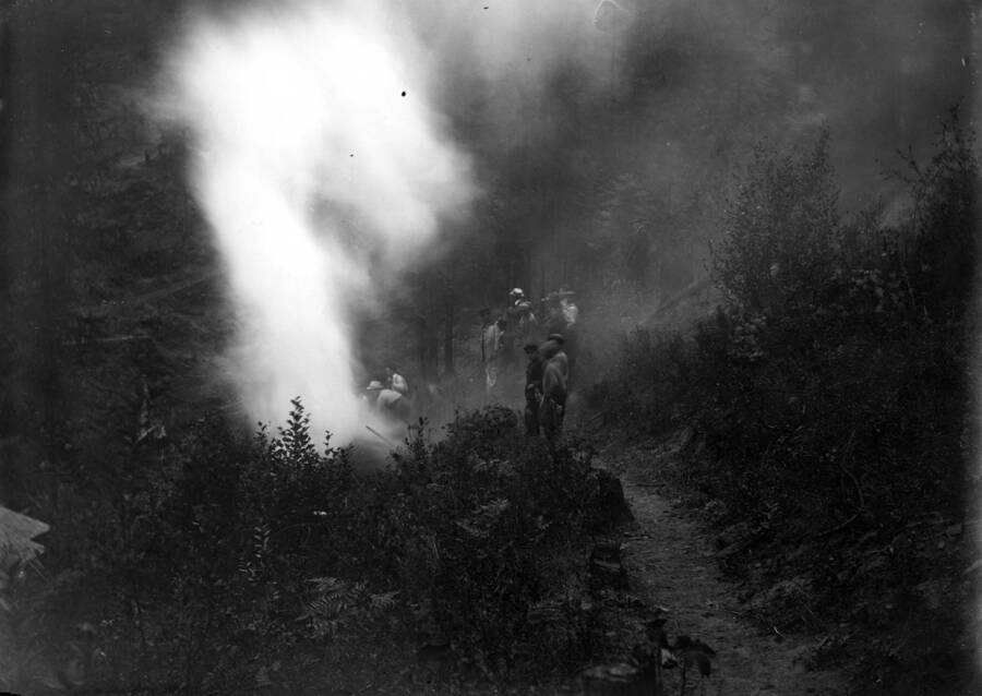 Image shows men working on the hill opposite of 6th St. in Wallace, Idaho. Forest fire 1910.