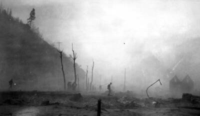 Image of Wallace, Idaho after the fire of August 20, 1910, people can be seen in the distance assessing the damage