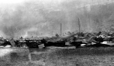 Image of Wallace, Idaho after the fire of August 20, 1910, appears to caputre a pile of burned-over debris from a building and maybe equipment