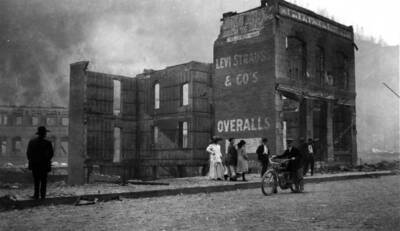 Image of Wallace, Idaho after the fire of August 20, 1910, with debris from a damaged building that bears the words "Levi Strauss & Co's Overalls"