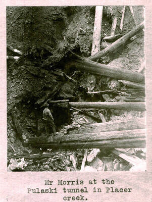 Image shows Mr. Morris at the Pulaski tunnel in Placer Creek. 1910 Forest fire. Copied from S.A. Woodbury.