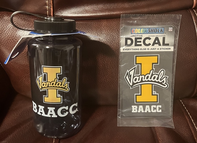 A waterbottle with the BAACC decal next to another BAACC decal sticker still