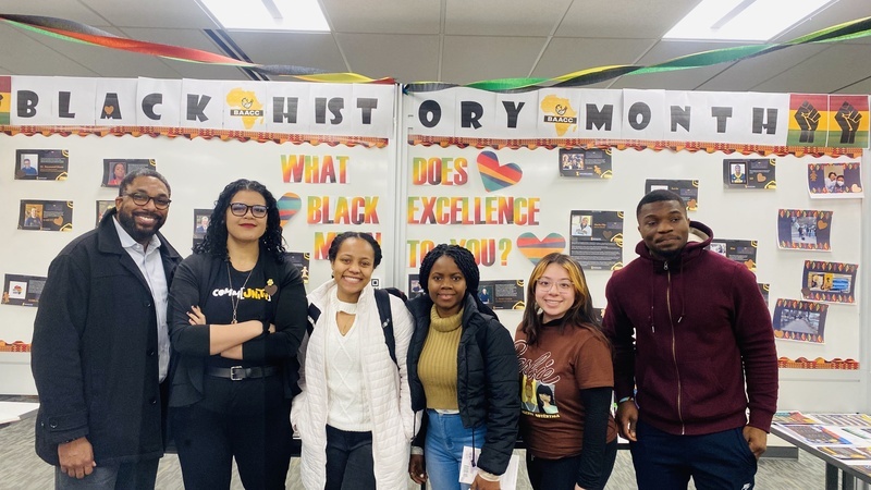 Students and staff standing in front of the 2023 Black History Month display.