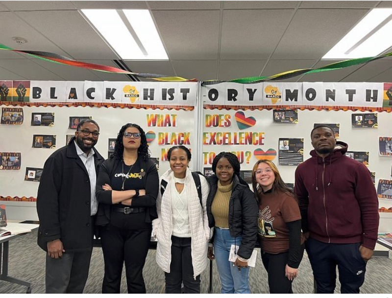 Students and staff in front of the Black History Month display in the U of I Library.