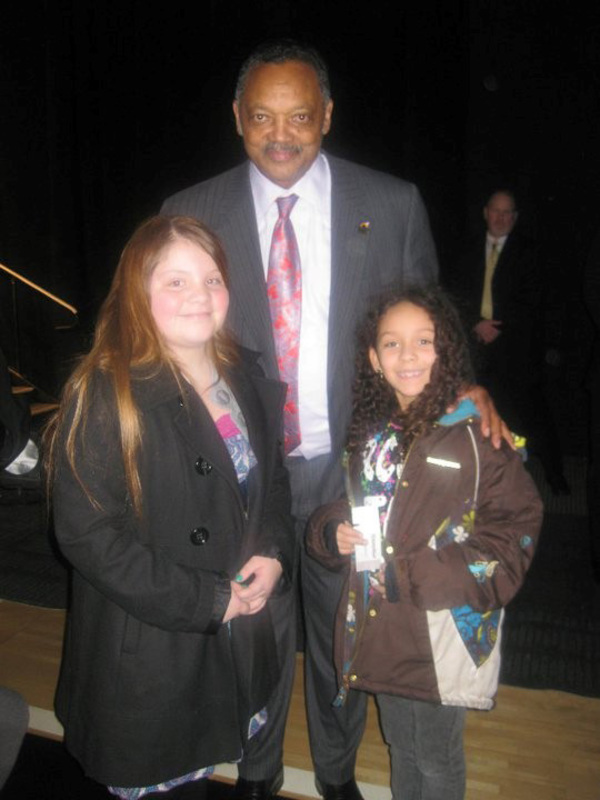 Reverend Jesse Jackson and two children at the University of Idaho Black History Month celebration in 2014.