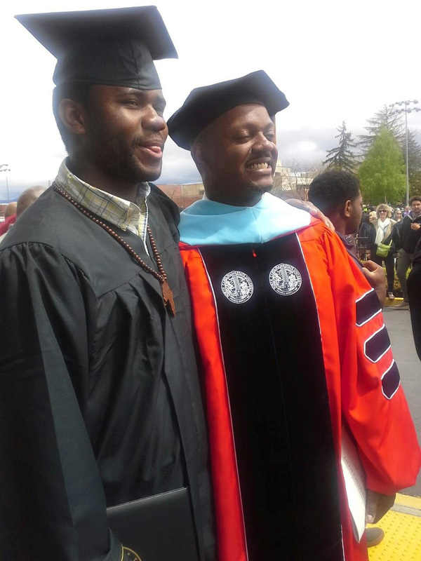 Hassel Andre Morrison, first Black Associate Dean of Students, and a student at commencement.