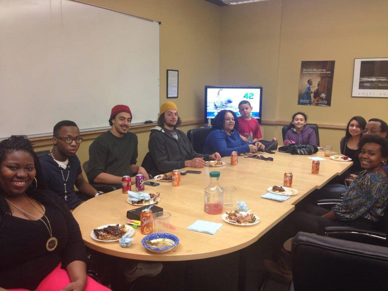 Students sitting around the table at a Soul Food Sunday event.