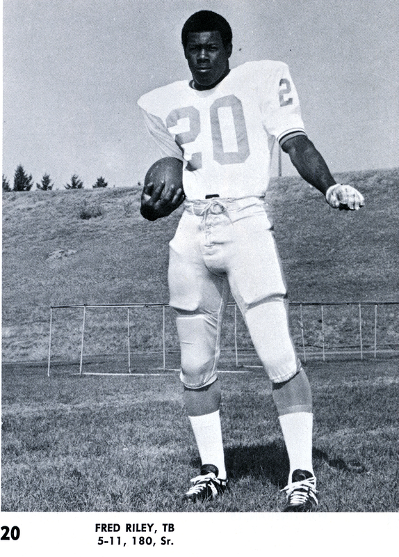 Portrait of Fred Riley holding a football.