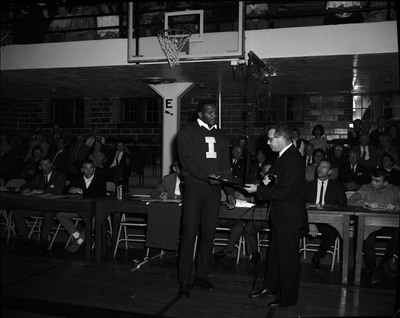 Football player Ray McDonald receiving All-American award from Paul Ostyn.