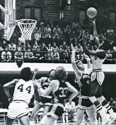 Evin Brown mid jump while several opponents and teammate surround him.
