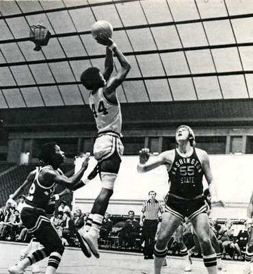 Mickey Brown mid jump as two WSU opponents surround him.