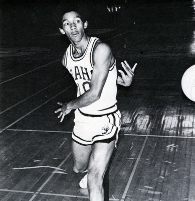 Tommy James throwing a basketball.