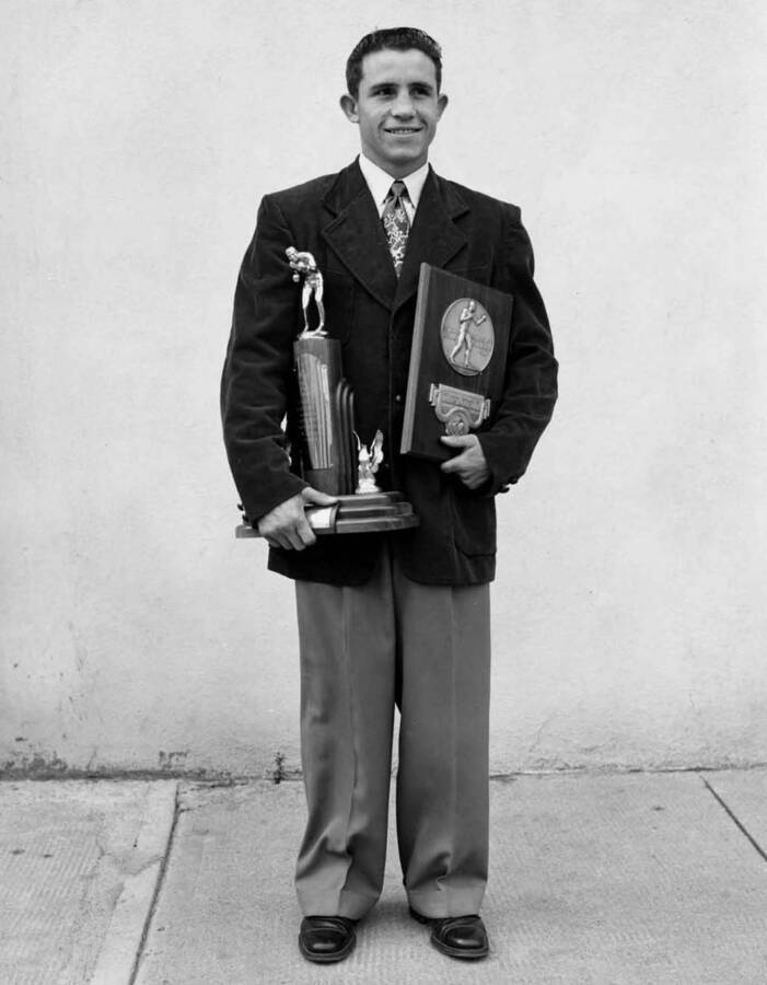 Frank Echevarria, University of Idaho boxer NCAA champ, 1951-52, with trophies - NCAA Champion 1951-52 