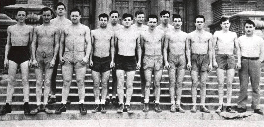 1933-1934 University of Idaho boxing squad - Front row: D. Butler, G. Gage, R. Sundberg, C. Fickes, L. Paskin, L. Denton, L. August, R. Ames, C. Greathouse, H. Coppedge.  Back row: M. Brigham, E. Hollinger, M. Fickes, E. Ritzheimer.; steps of Memorial Gym.