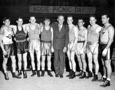 Pacific Coast Intercollegiate Boxing champions 1947 - Left to Right: Art Neumayer Gonzaga University, 125 lb.; Jack Nelson, WSC, 130 lb.; Ray Engberson UI, 135 lb.; Bob Anderson San Jose State College, 145 lb.; I. F. Toomey, Director of Athletes, Cal Aggies; Herb Carlson UI, 155 lb.; Wayne Fontes San Jose State, 165 lb.; Laune Erickson UI, 175 lb. div.; John Nikcevich UCLA, Heavyweight.