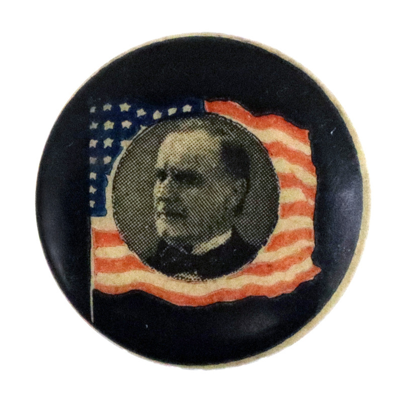 Round, black button with a portrait of William McKinley, bordered by the US flag.