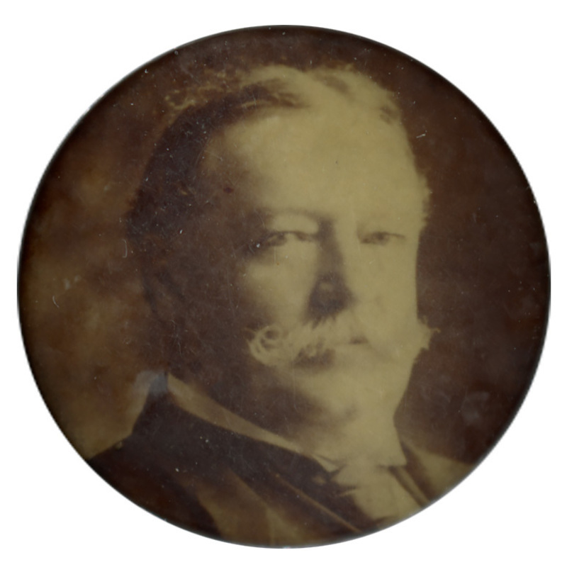 Round button with a black and white portrait of William Howard Taft.