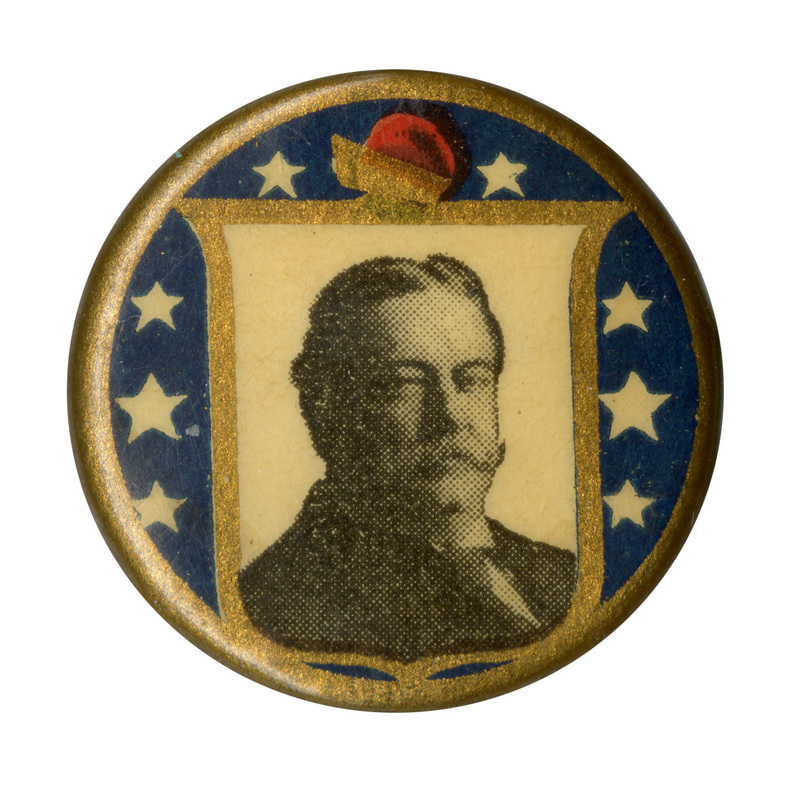 Round, blue button with a gold border and a centered, white insert with a portrait of William Howard Taft. 