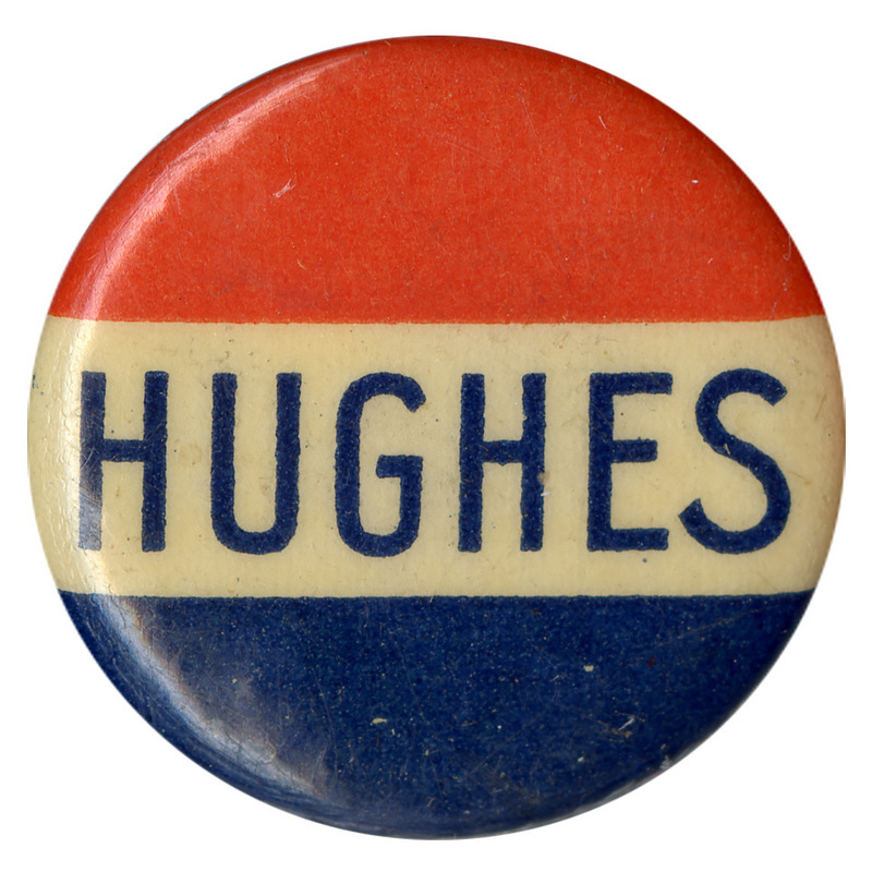 Round button with text reading "Hughes" in bold blue letters across a red, white, and blue striped background.