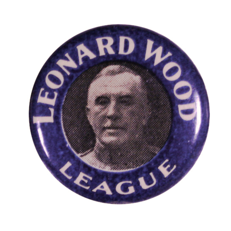 Round, blue button with a black and white portrait of Leonard Wood, and white text reading "Leonard Wood League". 