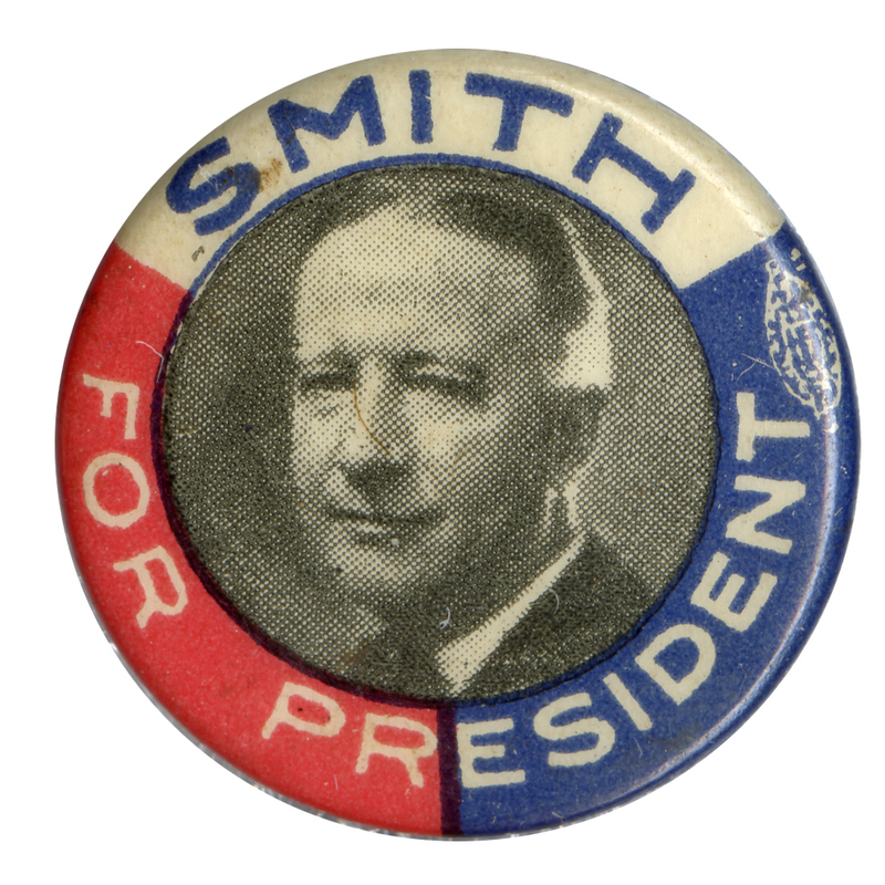 Round button with red, white, and blue trisected border, and black and white portrait of Alfred E. Smith. White and blue text surround the portrait, along the border and reads: "Smith for President". 