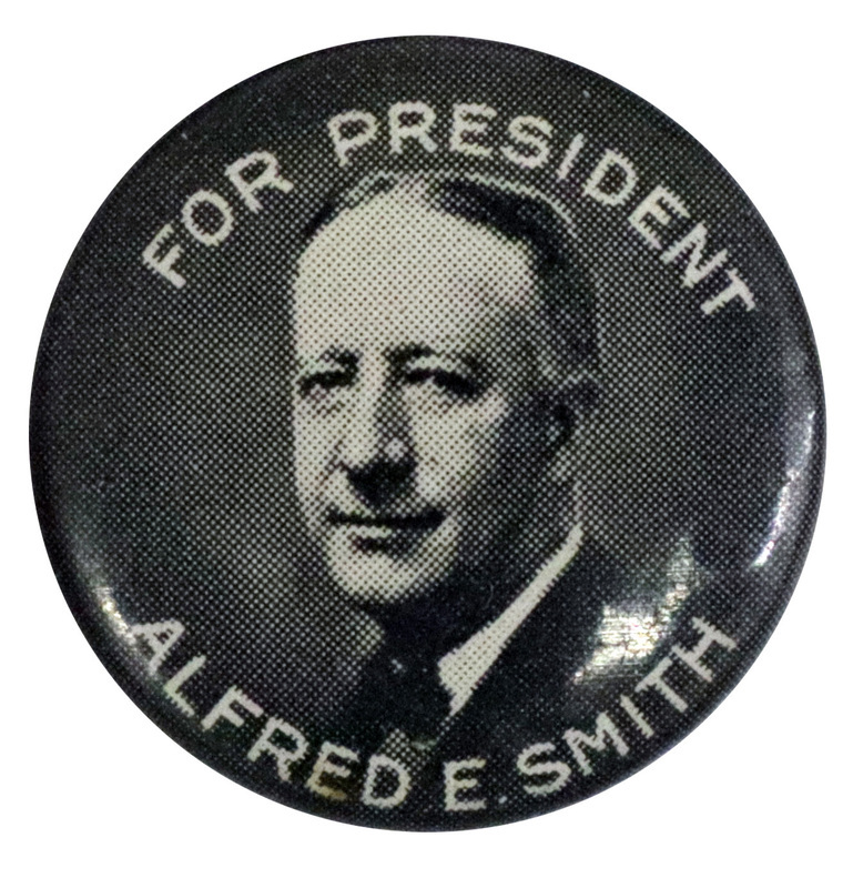Round, gray button with a black and white portrait of Alfred E. Smith, and white font reading "For President Alfred E. Smith". 
