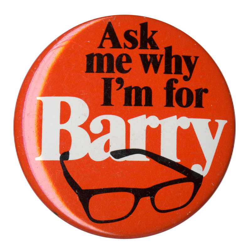 Round, orange button with a drawing of a pair of black-rimmed glasses and the text: "Ask me why I'm for Barry."