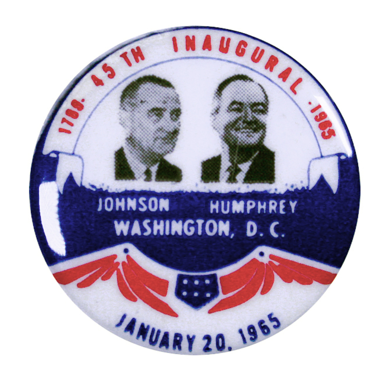 Round, white button with portraits of Lyndon B. Johnson and Hubert Humphrey and blue and red flag decorations. Text reads "1789 45th Inaugural 1965, Johnson Humphrey, D. C., January 20, 1965"