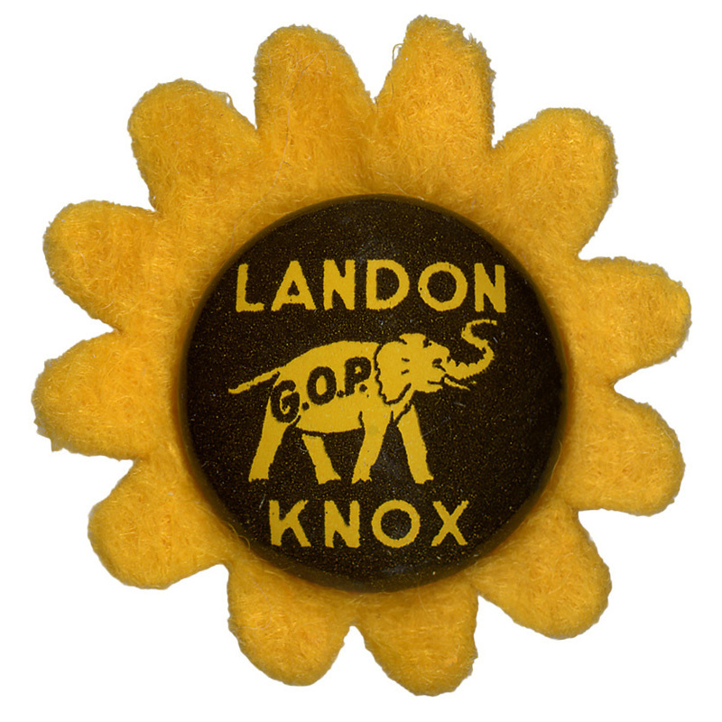 A round button with a yellow elephant with the letters "GOP" on the elephant's side. Yellow text reads "Landon Knox" on a brown background and sits atop a yellow flower-shaped felt piece.