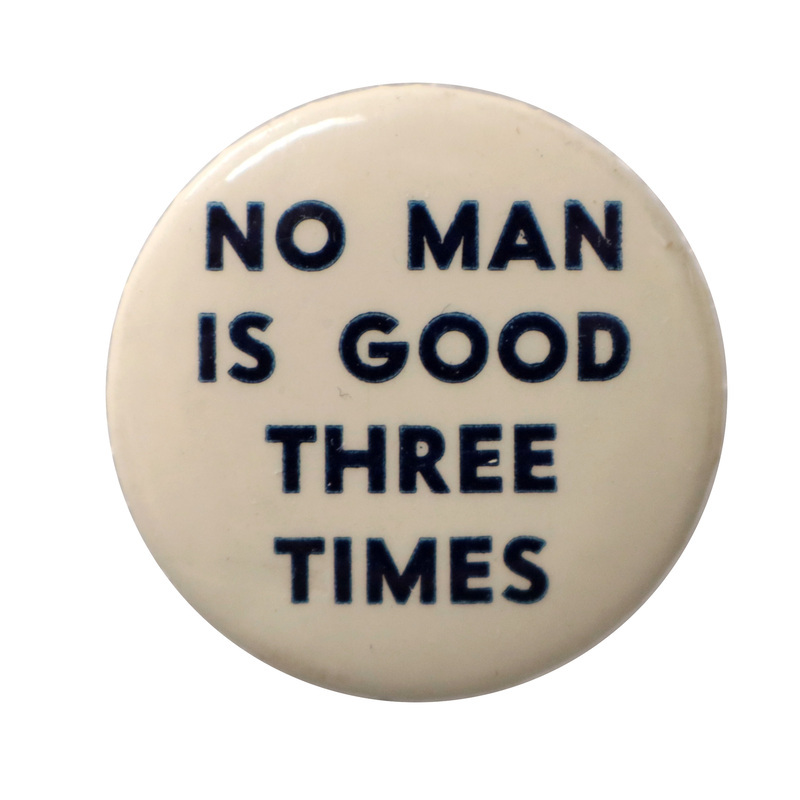 Round, white button with dark blue text reading "No man is good three times".