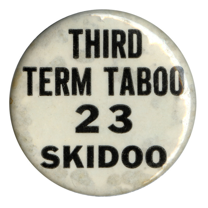 Round, white button with black text reading "third term taboo 23 skidoo". 