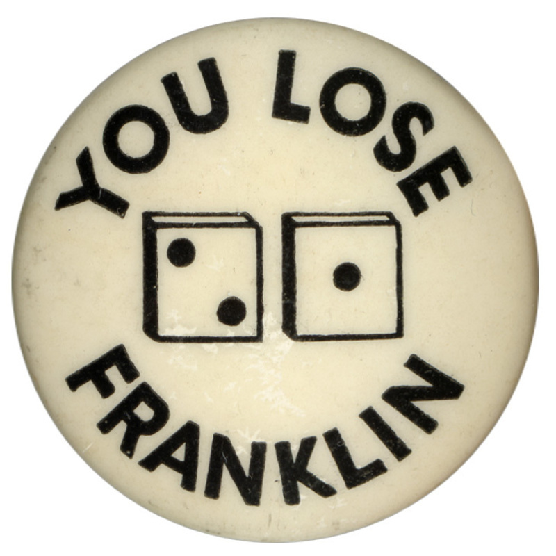 Round, white button with two dice at the center, one showing one pip, the other showing two pips. Black text encircling the dice reads "You lose Franklin". 