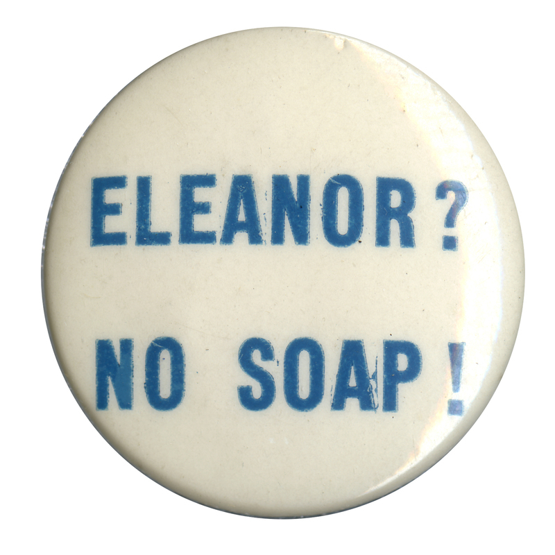 Round, white button with light blue text reading "Eleanor? No soap!". 