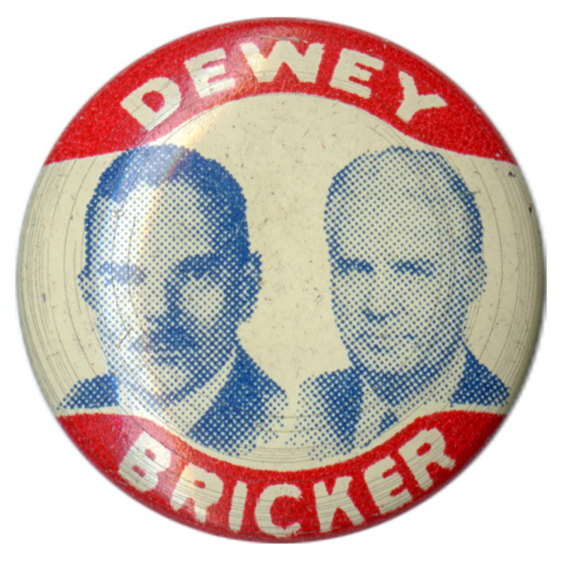 Round button with three horizontal stripes of red, white, and blue. White text reads "Dewey Bricker" with three blue stars in between. 