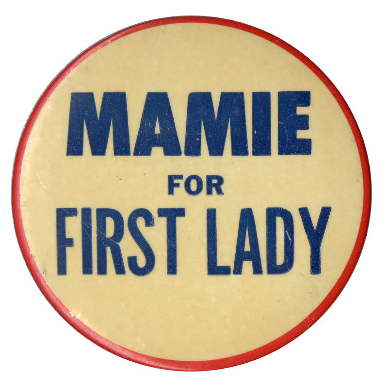 Round, off-white button with a thin red border and blue text reading "Mamie for First Lady". 
