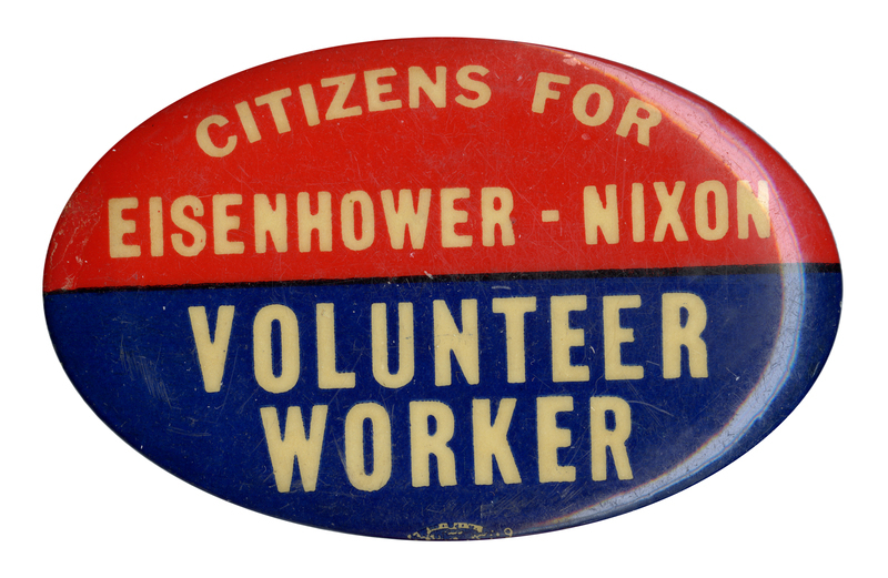 Oval, red and blue button with white text reading "Citizens for Eisenhower-Nixon Volunteer Worker". 