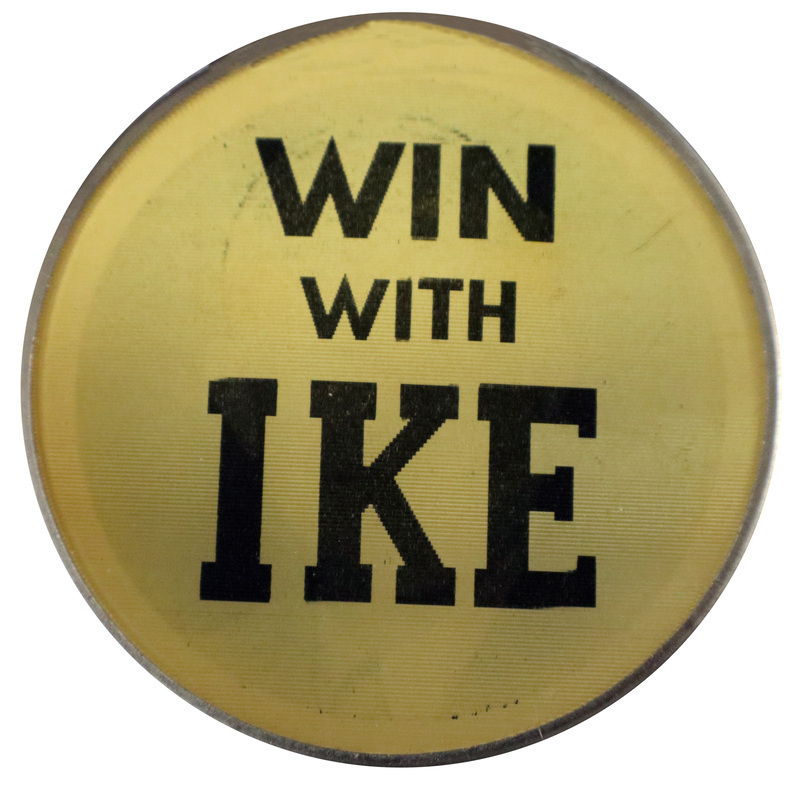 Round, black and white button with the text "Win with Ike." This is one angle of a holographic button.