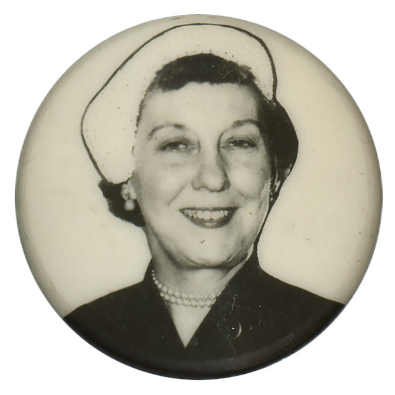 Round, white button with a grayscale portrait of Mamie Eisenhower. 