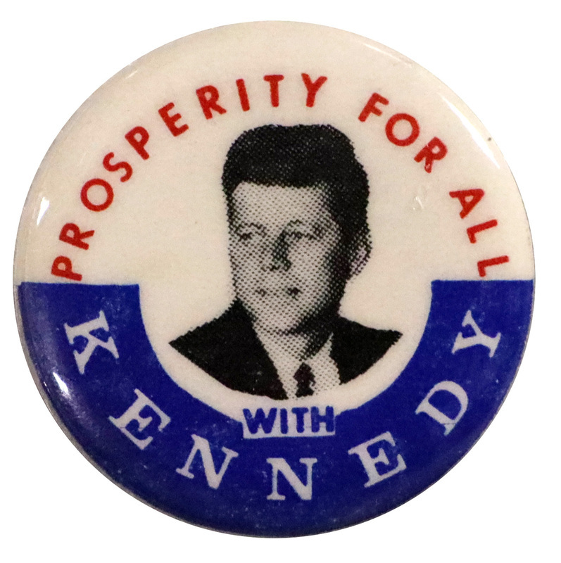 Round, white button with a blue border at the bottom and a grayscale portrait of John F. Kennedy at the center. Text reads "Prosperity for All with Kennedy". 